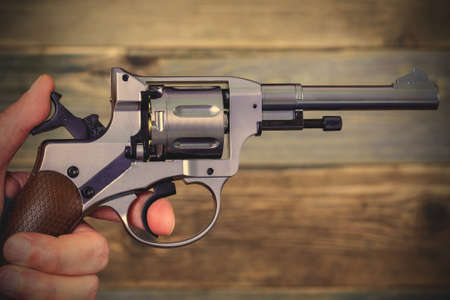 hand with revolver, close-up.