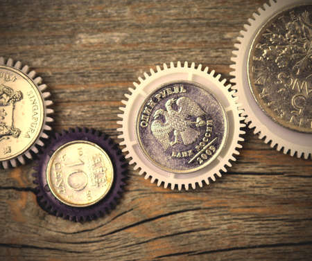coins engine on textureed wooden background, close up. business concept.  image filter retro styleの写真素材