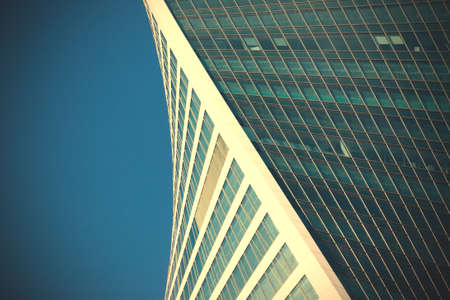 office building on the blue sky background. unusual urban architecture.  image filter retro styleの写真素材