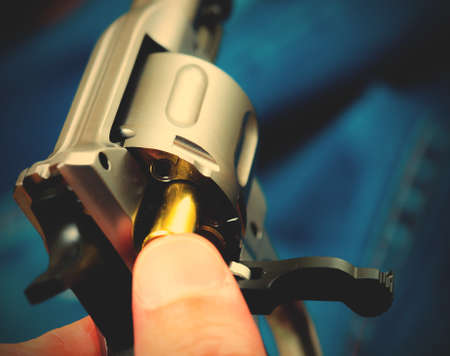Charging the drum of revolver, close up.  image filter retro styleの写真素材