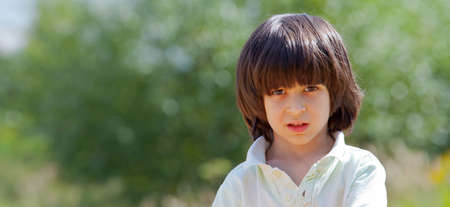 Portrait of a boy on a green backgroundの写真素材