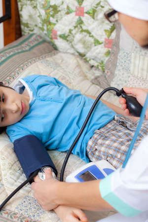 Doctor pediatrician measure blood pressure of boyの写真素材