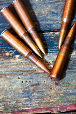 rifle cartridges on aged wooden surface