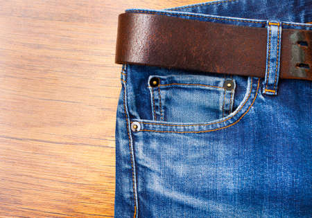 jeans with leather belt, aged and blueの写真素材
