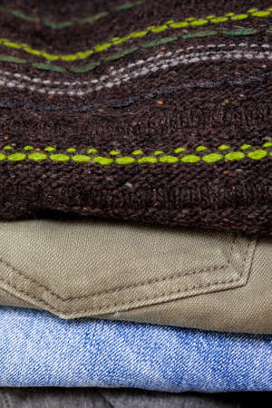 wool sweater, khaki and blue jeans in the stack. fashion, casual