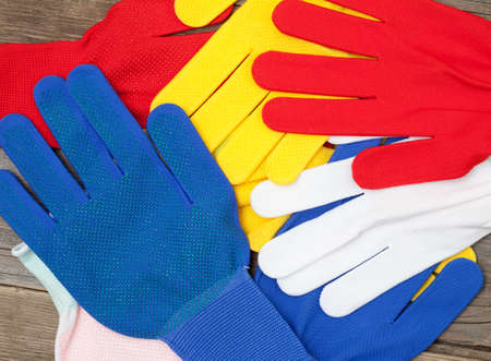 varicolored workers gloves on the counter of the storeの写真素材