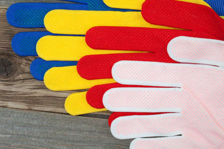 colorful set of working gloves on an old wooden surfaceの写真素材