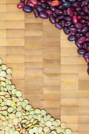 lentils and red kidney beans on a cork surface of the kitchen table. copy space. close up