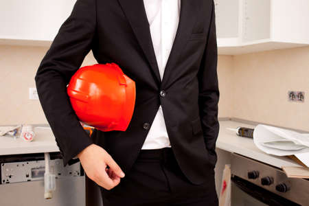 engineer or businessman  holding a helmet under his armの写真素材