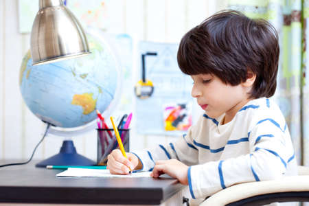 schoolchild doing homework at his desk