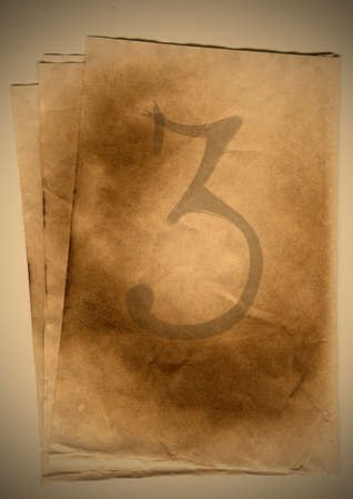 old paper with the inscription of threeの写真素材