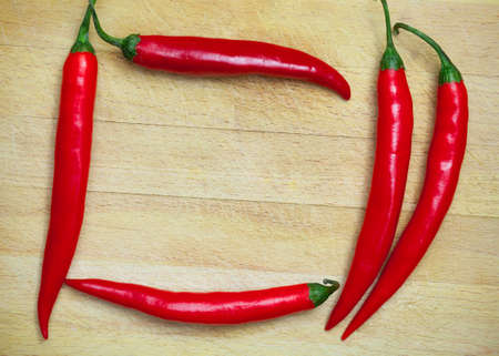 red hot chili peppers on the wooden backgroundの写真素材