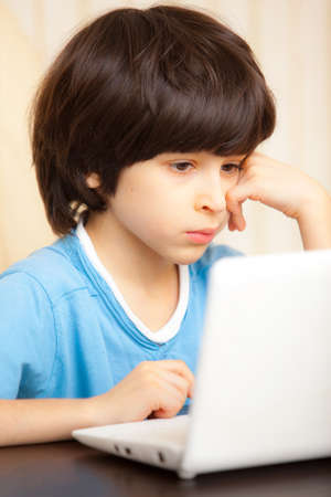 child looking at a computer monitor, distance learning