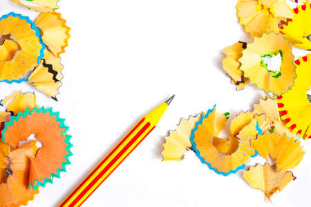 striped pencil and colored shavings on whiteの写真素材