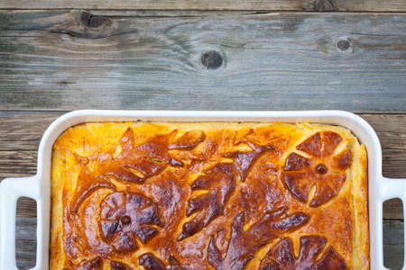 shred-pie in a white ceramic pot on vintage tableの写真素材