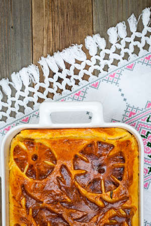 Pie with apple on the embroidered clothの写真素材