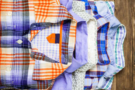 shirts in pile on old textured wood boardsの写真素材