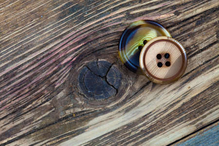 vintage buttons on aged surface of aged boardsの写真素材