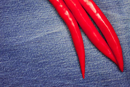 red hot chili pepper on jeans background, close upの写真素材