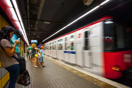 Spain, Catalonia, JUNE 14, 2013: Barcelona metro station with train in motion. ISO 1250, grain and noise. Editorial use onlyのeditorial素材