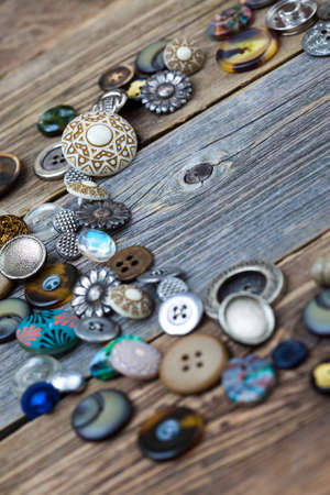 placer of vintage buttons on aged boards of old tableの写真素材