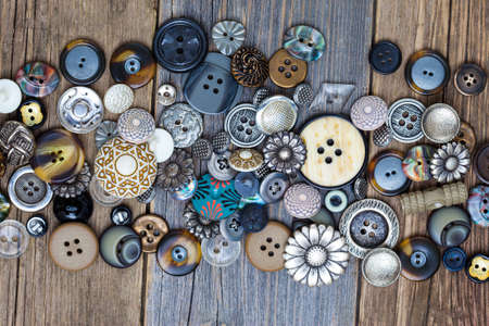 set of vintage buttons on aged table. close upの写真素材