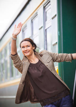 beautiful middle-aged woman returned from a trip and smilingの写真素材