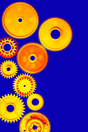 Orange gearwheels on a blue backgroundの写真素材