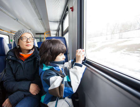 Mother and son in a railway carriage. winter tripの写真素材