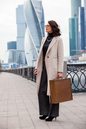 pretty woman holding old wooden case on ciry backgroundの写真素材