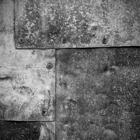 textured surface of old sheets of galvanized iron with rivetsの写真素材