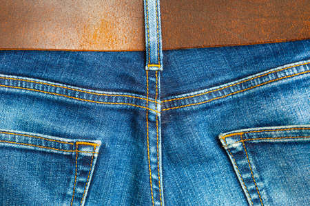 vintage blue denim with seams and leather belt,  part of の写真素材
