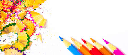 varicolored pencils and carnival shavings on white background with copy space.の写真素材