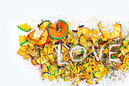 word Love on the white background of colored pencils shavings, still lifeの写真素材