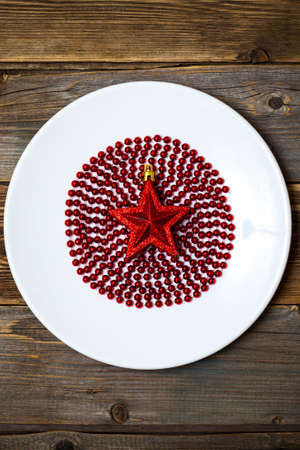 red star on the ruby ball in the white circle on the surface of the old wooden boards backgroundの写真素材