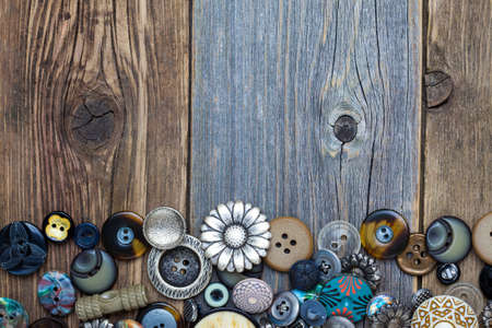 set of vintage buttons with copy space on aged boardsの写真素材