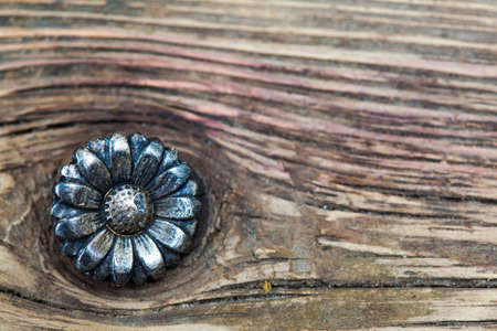 vintage button flower on the aged textured boards of the old tailor tableの写真素材