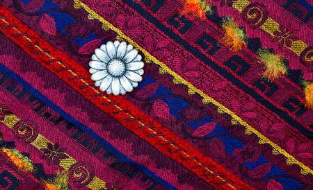 still life, vintage varicolored tape with embroidered ornaments and three old flower buttonの写真素材