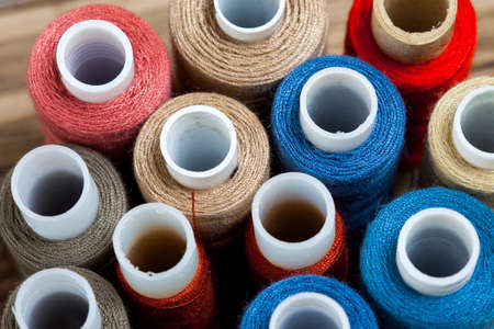 several varicolored spools of thread with copy space. shallow depth of field