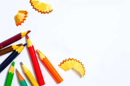 several aged pencils and shavings on white background with copy space, close upの写真素材