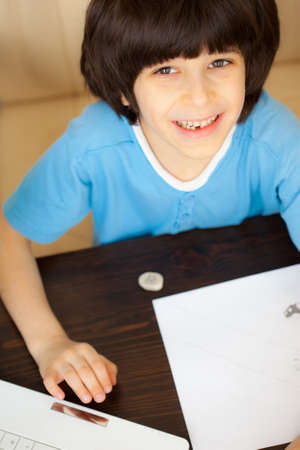 smiling child doing homework, portrait