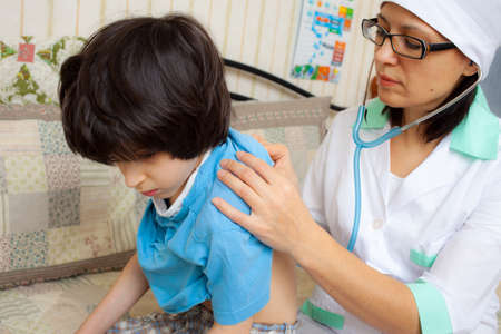 doctor therapists with stethoscope listening breath of boyの写真素材