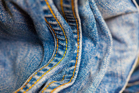 vintage Jeans with yellow stitching thread, close up. small depth sharpness