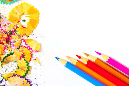 several colored pencils and shavings on white background with copy space, close upの写真素材