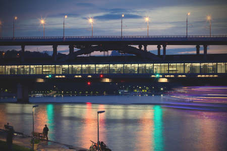 Moscow, Russia, Luzhniki Metro Bridge over the Moscow-river at dusk. Long exposure, blur in moving objectsのeditorial素材