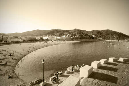 Catalonia, Spain, Tossa de Mar, JUNE 15, 2013: evening view of the bay Badia de Tossa and Gran Platja beach. monochrome retro styleのeditorial素材