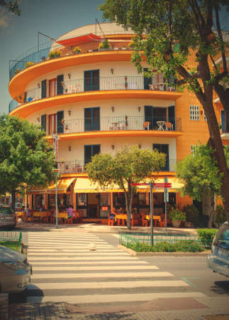 Tossa de Mar, Spain, JUNE 16, 2013: urban landscape with a pedestrian crossing and a white and orange buildingのeditorial素材
