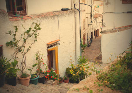Tossa de Mar, Spain, June 16, 2013: narrow streets of the old town of the 18th century with flowers in potsのeditorial素材