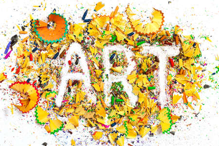 art word on the background of colored pencil shavings on the white paperの写真素材