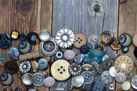 set of old buttons with copy space on aged boardsの写真素材